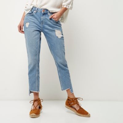 Mid blue wash ripped twisted seam jeans